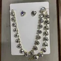 Sparkling heart-shaped crystal jewelry set including necklace and stud earrings in gold. - Clear