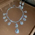 Close-up of sparkling teardrop pendant necklace and matching earring set with starburst shine. - Pear Cut Statement Pendant Style (24#)