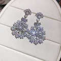 Close-up of French vintage snowflake earrings with zircons and pearls. - Silver