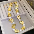 Detailansicht einer eleganten Halskette mit Goldstücken und Perlen in Schmuckschatulle - Halskette / Gold/Weiß