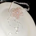 Detail view of pink chiffon flower and elegant pearl bead necklace on white plate - Chiffon Flower Choker / White-Pink