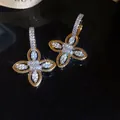 Exquisite close-up of 18k gold plated floral earrings featuring brilliant zircon stones - Flower Style / Gold