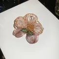 Close-up of vintage crystal beaded floral brooch with intricate embroidery details. - Elegant Floral / Pink