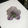 Detailed view of the handcrafted crystal beaded flower brooch with purple mesh petals. - Elegant Floral / Purple