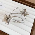 Close-up of silver flower arm cuff with textured metallic bands and layered petals - 8# Hollow Double Floral Design / Silver