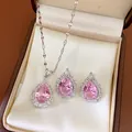 Close-up of an elegant pink teardrop necklace and earrings jewelry set in a display box - Necklace and Earrings Set / Silver-Pink
