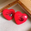 Elegant red heart-shaped resin stud earrings with artistic black ink swirl pattern - Heart Stud Earrings