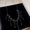 Elegant metal tassel necklace with sparkling accents displayed in a black jewelry box - Silver