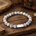 Macro view of white turquoise beads and personalized engraved metal bar with Thomas - 1 Side Engraving / Howlite