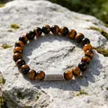 Macro detail of custom engraved metal plate on tiger eye stone beaded bracelet - 1 Side Engraving / Tiger's Eye