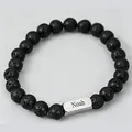 Macro shot of lava stone beaded bracelet with engraved silver Noah metal plate detail - 1 Side Engraving / Lava Stone