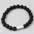 Macro shot of lava stone beaded bracelet with engraved silver Noah metal plate detail - 1 Side Engraving / Lava Stone