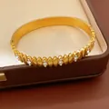 Close-up of gold-plated stainless steel bangle with zircon-embedded oval patterns - 5# Bracelet-Gold
