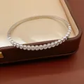 Detail of stainless steel heart bangle with micro-pave zirconia settings on jewelry box. - 1# Bangle-Silver