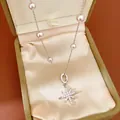 Close-up of elegant starburst pearl necklace with zircons in a jewelry box - Necklace (HN11773) / Silver-Pink