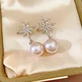 Detailed macro shot of elegant silver star-shaped earrings with pink pearl drops - Earring Post (HE32715) / Silver-Pink