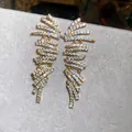 Macro view of luxurious 18k gold-plated geometric earrings with sparkling clear zircon - Geometric Tassel (HE33170) / Gold