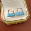 Close-up of elegant blue turquoise handbag-shaped hoop earrings in a gift box - Huggie (HE32617) / Blue