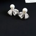 Elegant detail of 18K gold plated lace bow stud earrings with white pearl and zircons - Lace Bow Knot Style (HE33196) / Silver
