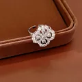 Detailed view of a sparkling silver open ring featuring an intricate zircon flower motif - Hollow Flower / Silver