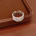 Macro view of exquisite silver hollow open ring set with sparkling zircons on jewelry tray - Zirconia Edge Style / Silver