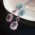Macro detail of multi-colored zircon earrings with blue, red, and purple gemstones - Three-Color Drop Style (HE33211)