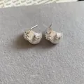 Detailed view of elegant silver flower stud earrings featuring sparkling zircon accents - Silver