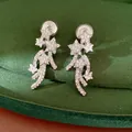Close-up of elegant star-shaped clip-on earrings paved with sparkling cubic zirconia - Star Zirconia Style / Silver