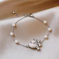 Vista dettagliata del bracciale con zircone a forma di cuore e perle su elegante raso. - Stile Fiocco Cuore 8#