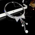 Detail view of a sparkling rhinestone bow necklace with elegant pearl tassels - Silver