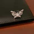 Detailed macro view of a silver butterfly adjustable ring featuring a central zircon stone - Ring (Adjustable) / Silver