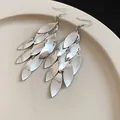 Close-up of elegant silver metal leaf tassel earrings showing textured leaf hook design. - Style 2 Hook Silver