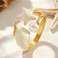 Close-up of gold open ring with cream enamel starfish, conch and pearl details - Open Ring (8809) / Gold (Starfish Snail Style)