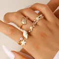 Close-up detail of beach themed gold open rings featuring starfish shell and turtle charms - 4-Piece Set (05 Medium KC Gold) / 4 Pieces / Gold