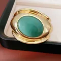 Close-up view of a chunky gold open cuff bracelet featuring a large green oval stone - Green Aventurine (HB5741) / Gold