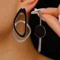 Close-up of asymmetric geometric earrings featuring silver metal and black enamel finish - Asymmetric Geometric Style (DZ-1009) / White Gold Black Enamel