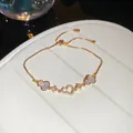 Detailed macro shot of 18k gold plated adjustable bracelet with zircon heart charms - Bracelet (Style 2)
