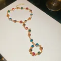Macro view of a colorful dopamine-style crystal integrated ring bracelet in golden finish - Gold-Multicolor Round Stone Style