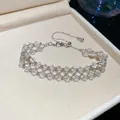 Exquisite close-up of a woven crystal mesh bracelet resting in a beige velvet jewelry box - 42# Bracelet / Silver-White