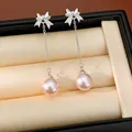 Détail de boucles d'oreilles nœud argenté avec perles roses pendantes - Rose