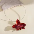 Detailed macro shot of a glossy red enamel flower pendant on a thin silver wire choker - Choker (HN11956) / Red
