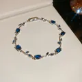 Exquisite detail view of a silver vine-style bracelet featuring oval and marquise blue stones - Blue Vine / Silver