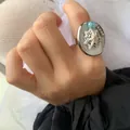 Macro detail of ocean-themed adjustable ring featuring seashell and blue bead accents - Silver-White