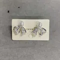 Elegant bowknot pearl stud earrings with delicate silver lace mesh design on card - Silver Bowknot Style (HE33196)