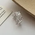 Close-up of exquisite hollow flower ring with shiny zircons in S925 sterling silver finish. - Open Hollow Flower Style / Silver