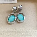 Detailed view of elegant silver oval stud earrings with turquoise acrylic pendants - Oval Pendant (HE33150) / Lake Blue