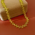 Close-up detail of olive green faceted glass beads on a delicate 14k gold plated necklace - 14K Gold Plated Clavicle Chain / Olive Green