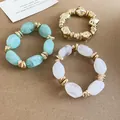 Close-up of three-piece set of irregular acrylic and gold-tone elastic bracelets - 49# Bracelet / Three-Piece Set / Gold-Cyan-Transparent