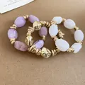 Detail view of stylish three-piece irregular acrylic and gold metal beaded elastic bracelet set - 47# Bracelet / Three-Piece Set / Gold-Purple-Transparent