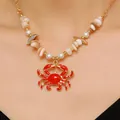Close-up of a bohemian red crab pendant necklace featuring shell beads and faux pearls - Red Crab Stone Pearl Beaded Chain (2972) / Gold